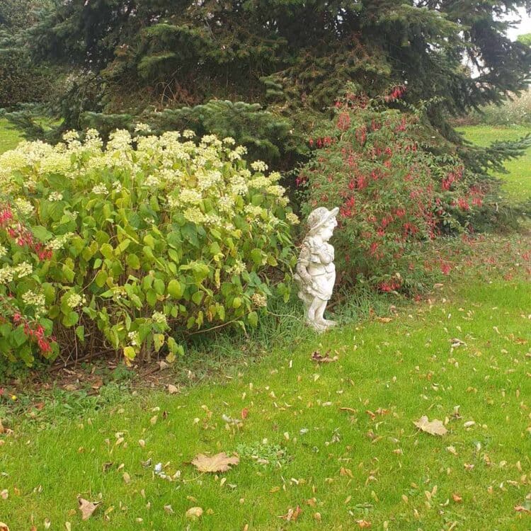 026-Sculpture in front of flower bed
